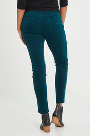 Model Aiyana wearing size 10 of the Skinny Leg Cord Pull On Pant in colour Peacock (Green), from the back