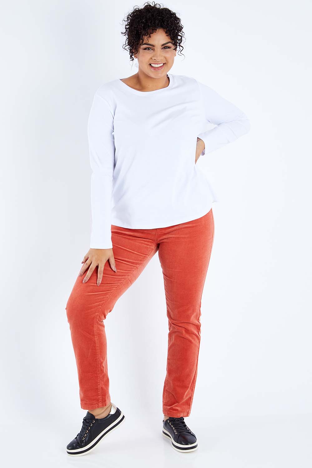 Model Sasha-Lee wearing size 16 of the Pin Cord Slim Pant in colour Auburn, from the front, showing the whole outfit