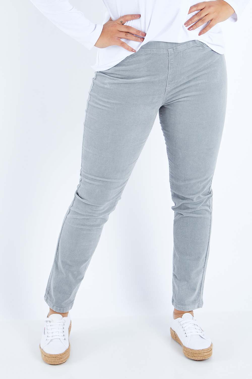 Model Sasha-Lee wearing size 16 of the Pin Cord Slim Pant in colour Cloud (Blue), from the front, cropped image