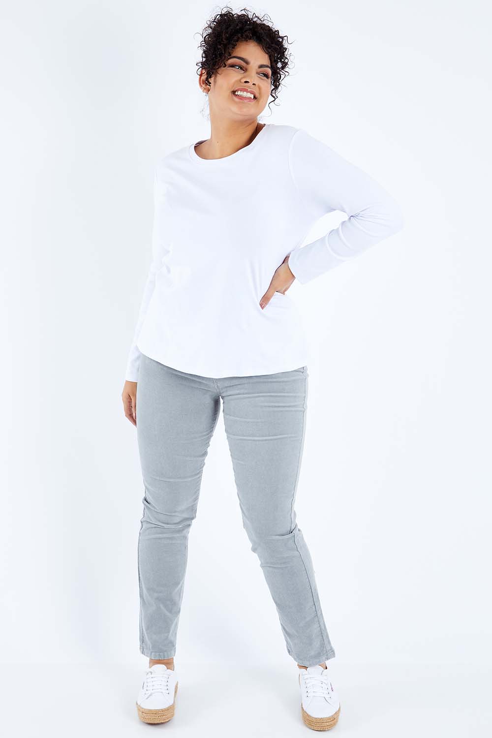 Model Sasha-Lee wearing size 16 of the Pin Cord Slim Pant in colour Cloud (Blue), from the front, showing the whole outfit