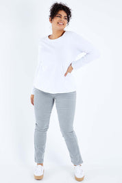 Model Sasha-Lee wearing size 16 of the Pin Cord Slim Pant in colour Cloud (Blue), from the front, showing the whole outfit