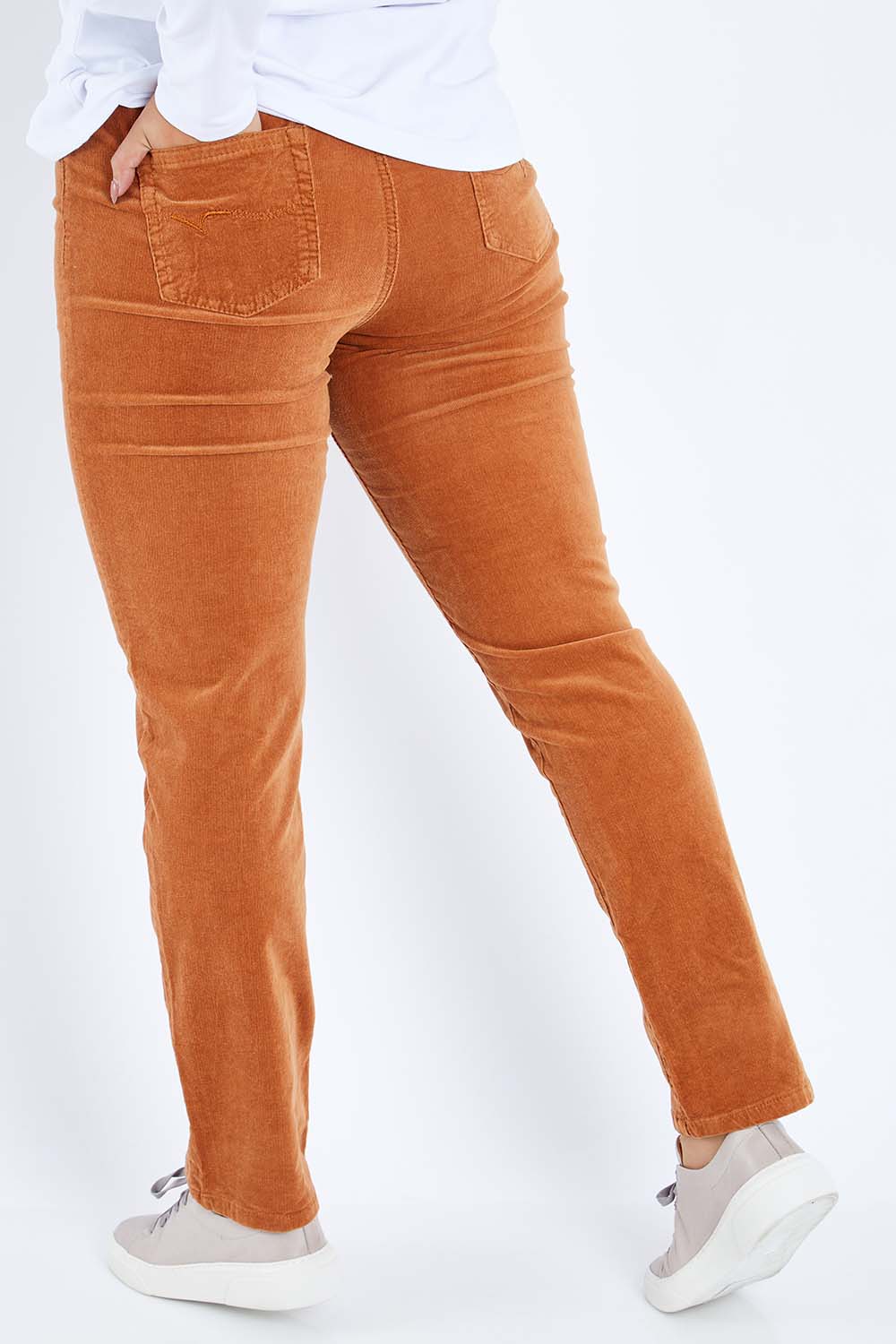 Model Sasha-Lee wearing size 16 of the Pin Cord Slim Pant in colour Copper, from the back