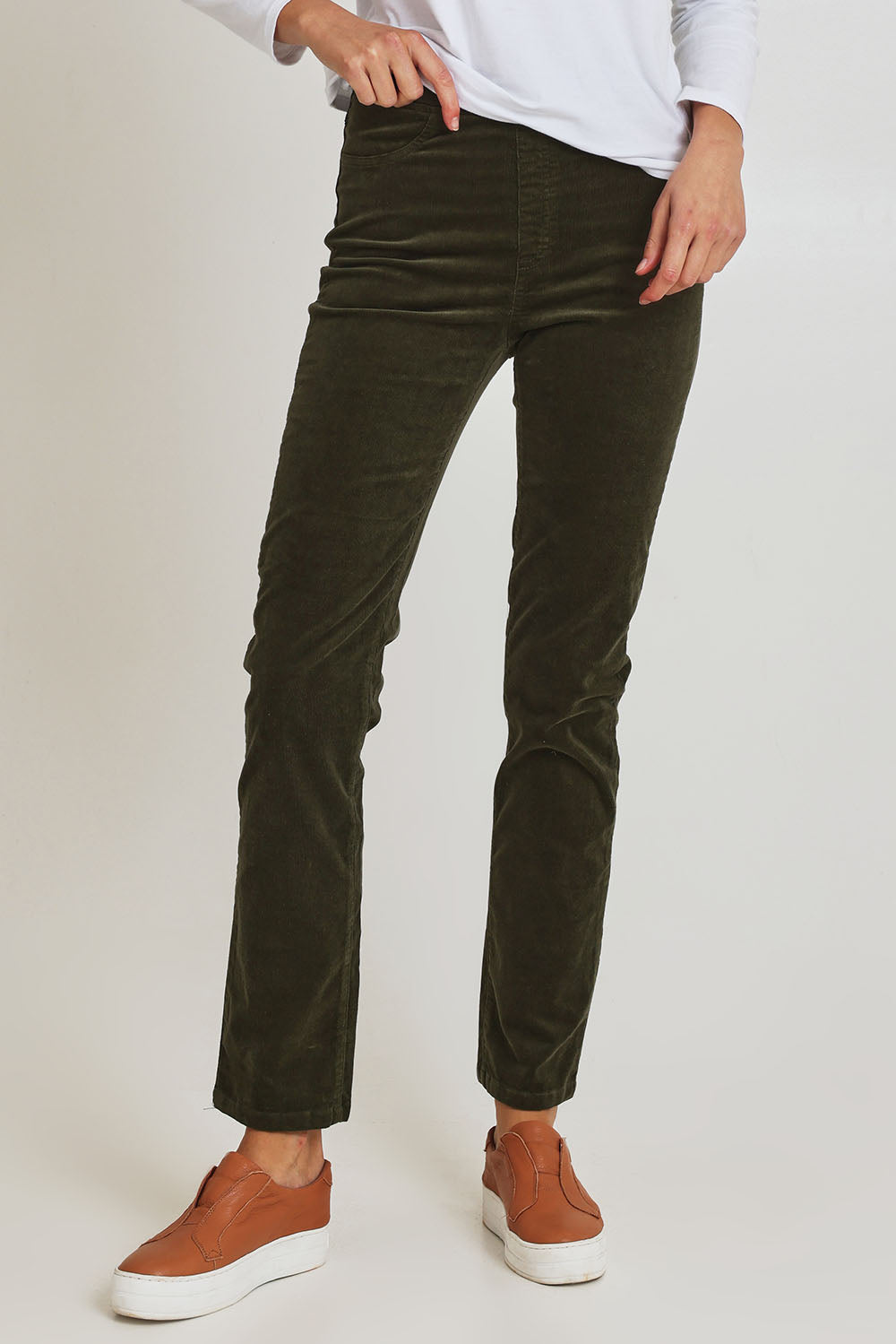 Model Madeline wearing size 10 of the Pin Cord Slim Pant in colour Deepsage (Green), from the front, cropped image