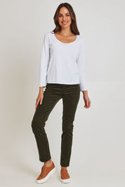 Model Madeline wearing size 10 of the Pin Cord Slim Pant in colour Deepsage (Green), from the front, showing the whole outfit
