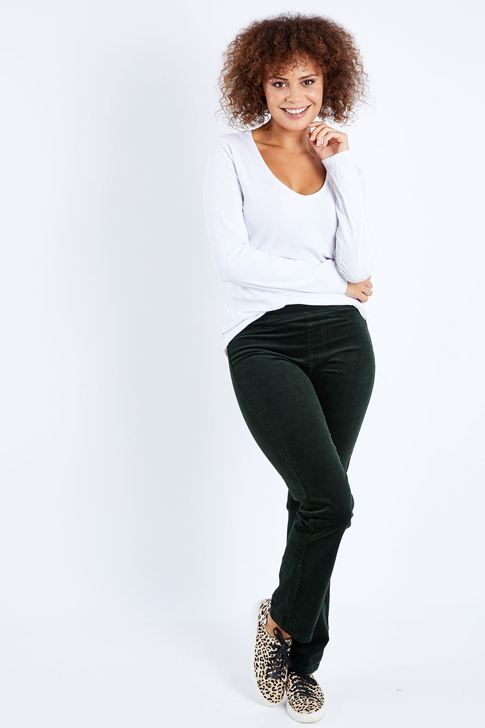 Model Lala wearing size 10 of the Pin Cord Slim Pant in colour Forest (Green), from the front, showing the whole outfit
