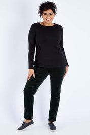 Model Sasha-Lee wearing size 16 of the Pin Cord Slim Pant in colour Forest (Green), from the front, showing the whole outfit