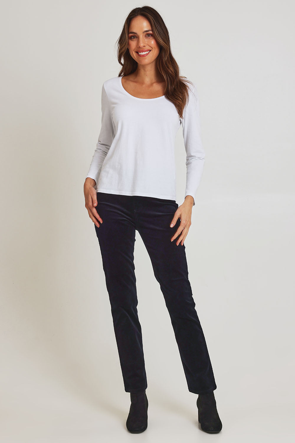 Model Madeline wearing size 10 of the Pin Cord Slim Pant in colour Midnight (Blue), from the front, showing the whole outfit