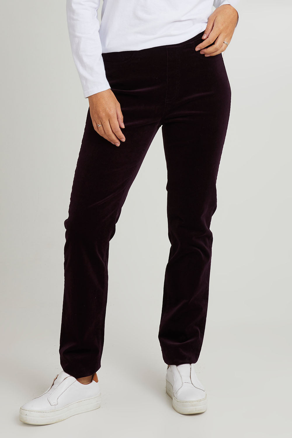 Model Katie wearing size 10 of the Pin Cord Slim Pant in colour Mulberry (Purple), from the front, cropped image