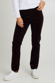 Model Katie wearing size 10 of the Pin Cord Slim Pant in colour Mulberry (Purple), from the front, cropped image