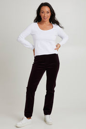 Model Katie wearing size 10 of the Pin Cord Slim Pant in colour Mulberry (Purple), from the front, showing the whole outfit