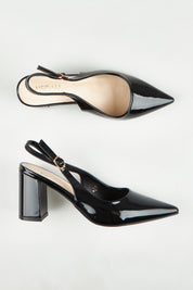 A model wearing size 37 of the Elio Slingback Block Heel in colour Blackpaten (Black), from the front, showing the whole outfit