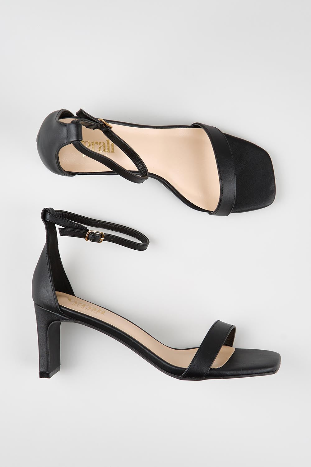 Model Genericm wearing size sample of the Gimlet Heel - Black in colour Black, from an angle