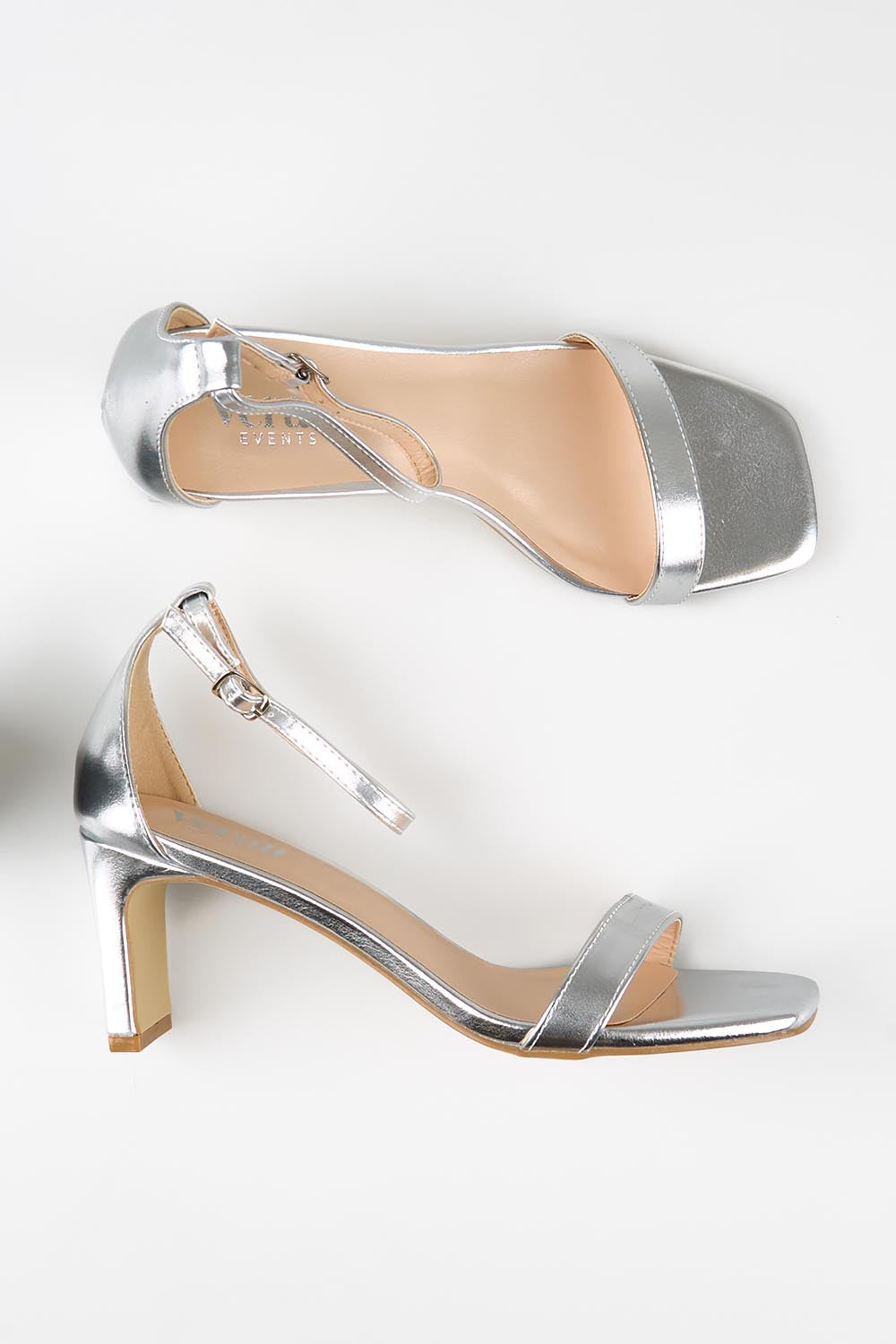 Model Genericm wearing size sample of the Gimlet Heel - Silver in colour Silver, from an angle