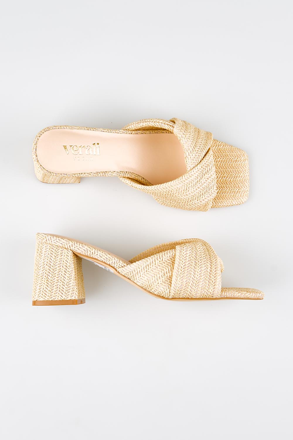 Model Genericm wearing size sample of the Stella Block Heel Mule - Naturalraffia in colour Naturalraffia, from an angle