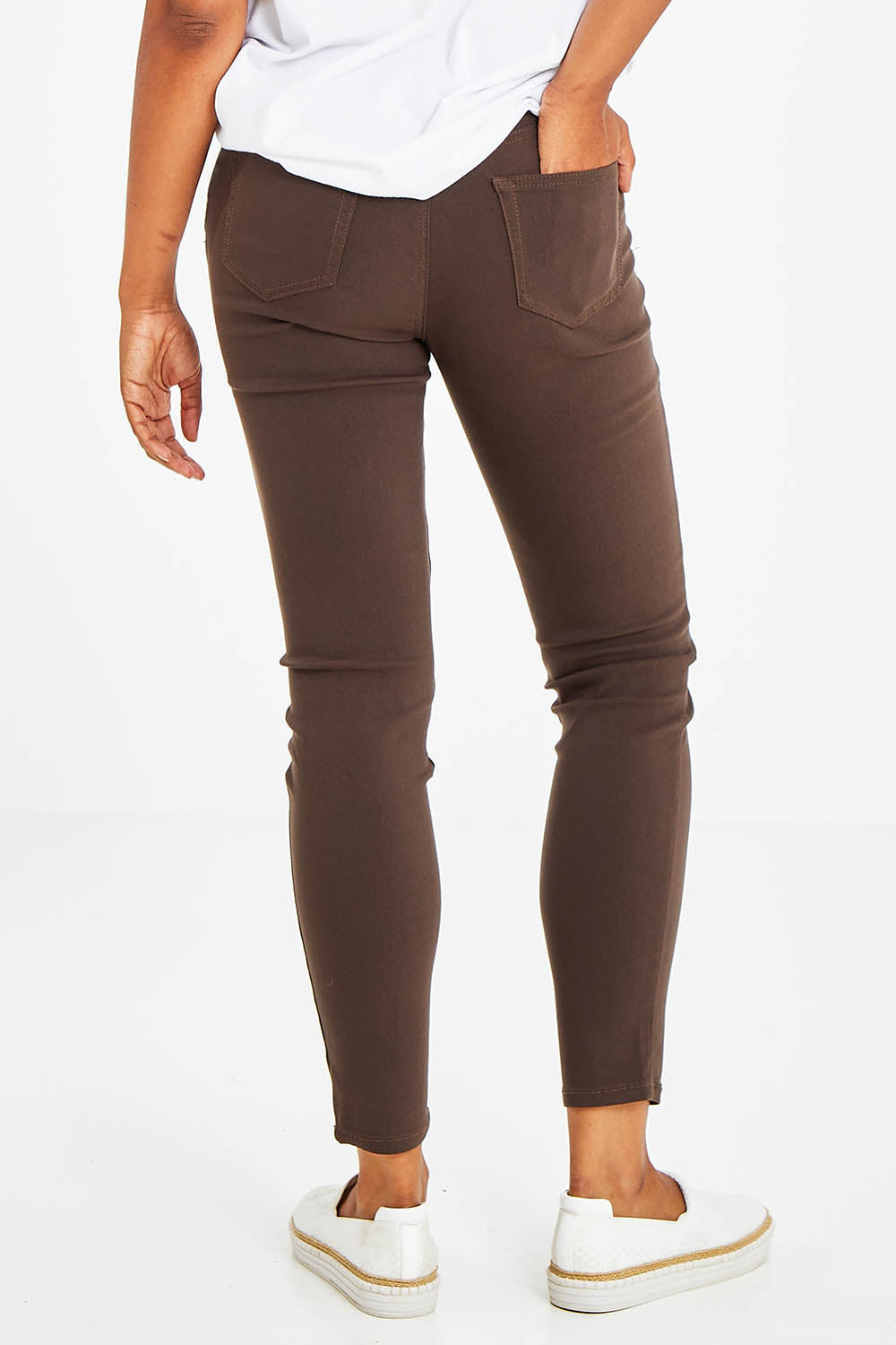 Model Olivia wearing size 10 of the Raven Skinny in colour Chocolate, from the back