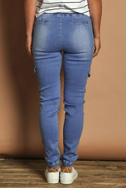 Model Katie wearing size 10 of the Harlow Cargo Jogger in colour Middenim (Blue), from the back