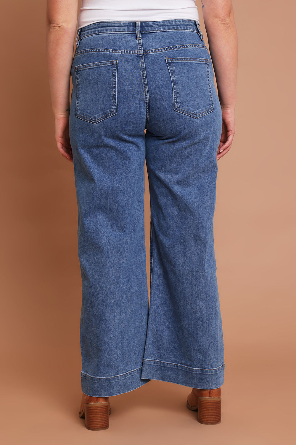 Model Chanel wearing size 16 of the Charlotte High Waisted Front Pocket Wide Leg Jean in colour Middenim (Blue), from the back