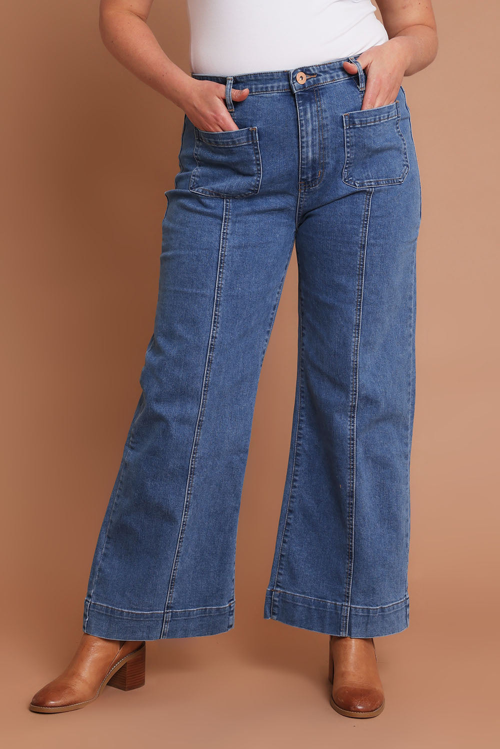 Model Chanel wearing size 16 of the Charlotte High Waisted Front Pocket Wide Leg Jean in colour Middenim (Blue), from the front, cropped image