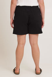 Model Chanel wearing size 16 of the Kate Highin colourWaisted Shorts - Black (Black), from the back