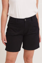 Model Chanel wearing size 16 of the Kate Highin colourWaisted Shorts - Black (Black), from the front, cropped image