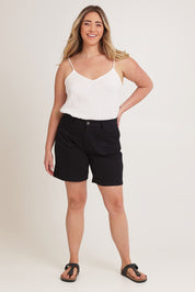 Model Chanel wearing size 16 of the Kate Highin colourWaisted Shorts - Black (Black), from the front, showing the whole outfit