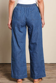Model Riinar wearing size 10 of the Maya Wide Leg Drawstring Jean - Middenim in colour Middenim, from the back