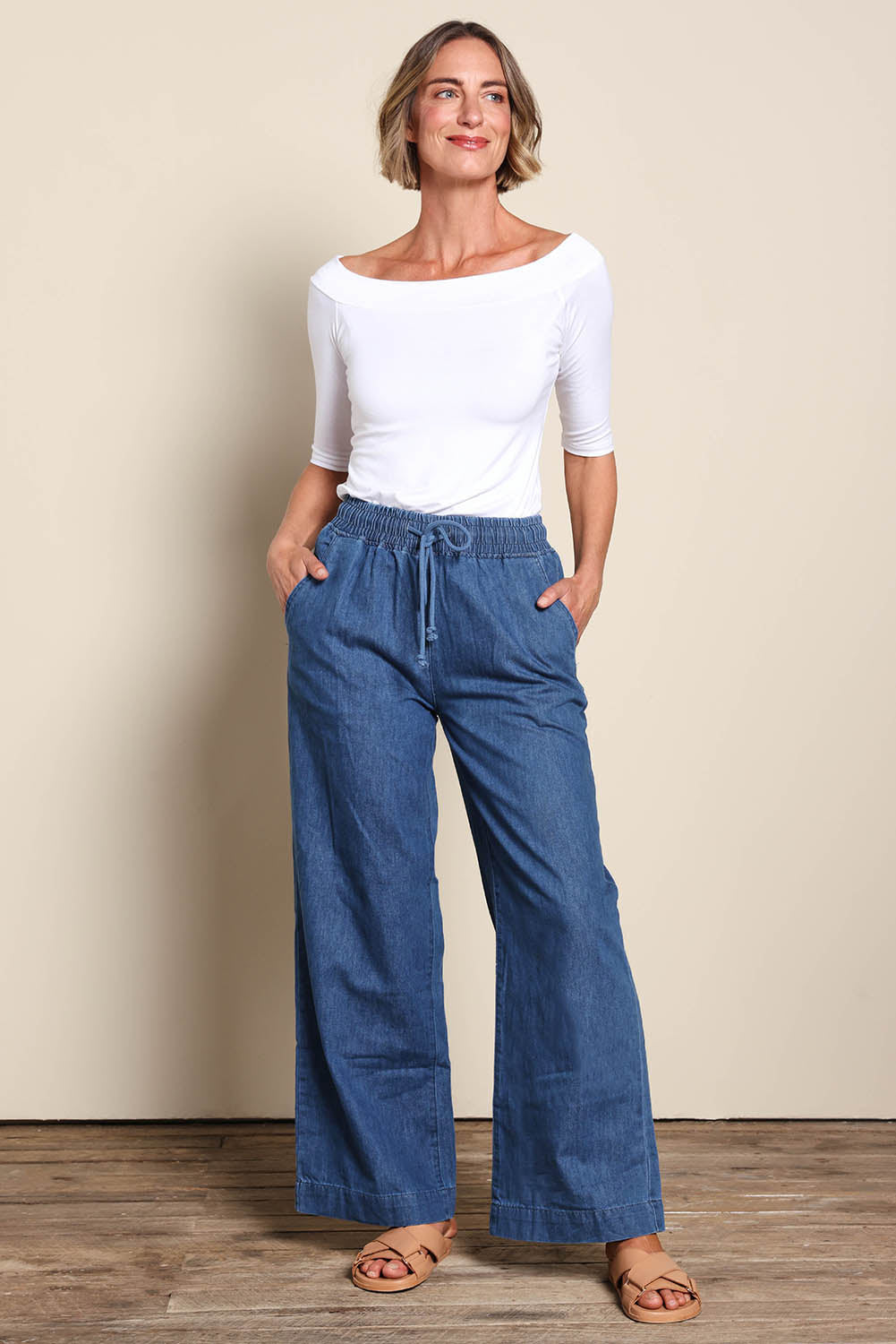 Model Riinar wearing size 10 of the Maya Wide Leg Drawstring Jean - Middenim in colour Middenim, from the front