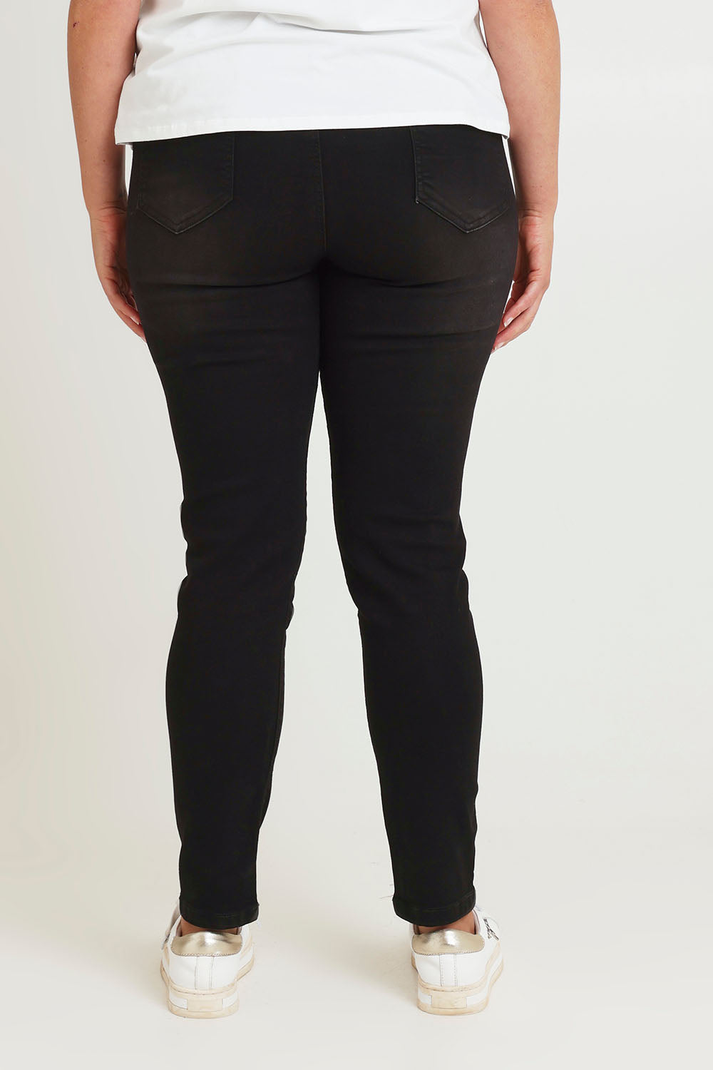Model Chanel wearing size 16 of the Paige Pull On Jean in colour Black (Black), from the back