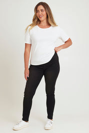 Model Chanel wearing size 16 of the Paige Pull On Jean in colour Black (Black), from the front, showing the whole outfit