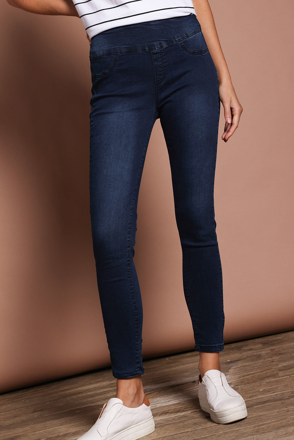 Model Madeline wearing size 9 of the Paige Pull On Jean in colour Darkblue (Blue), from the front, cropped image