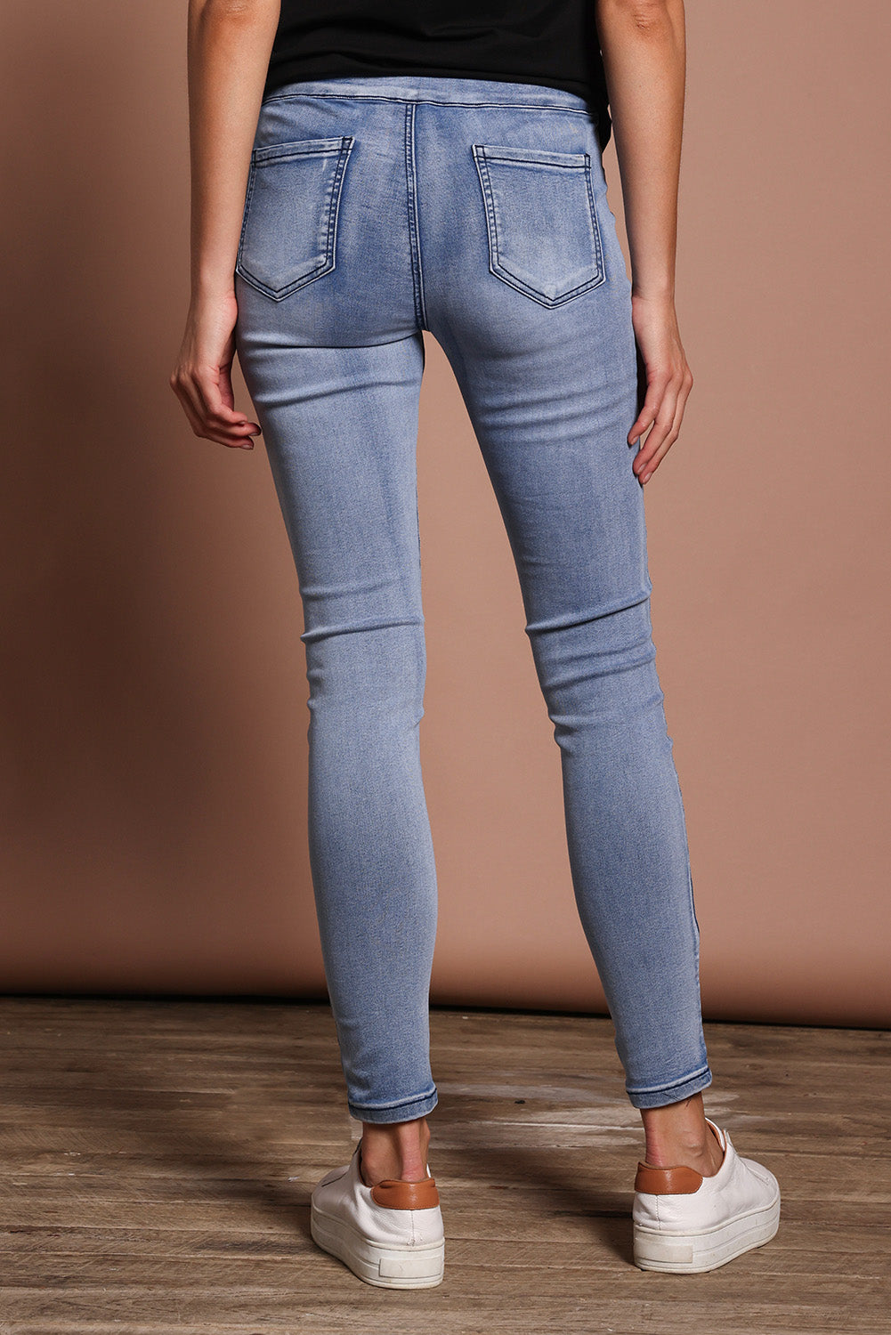 Model Madeline wearing size 9 of the Paige Pull On Jean in colour Lightblue (Blue), from the back