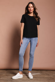 Model Madeline wearing size 9 of the Paige Pull On Jean in colour Lightblue (Blue), from the front, showing the whole outfit