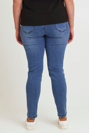 Model Chanel wearing size 16 of the Paige Pull On Jean in colour Midblue (Blue), from the back