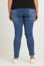 Model Chanel wearing size 16 of the River Ribbed Pull On Jean in colour Midblue (Blue), from the back