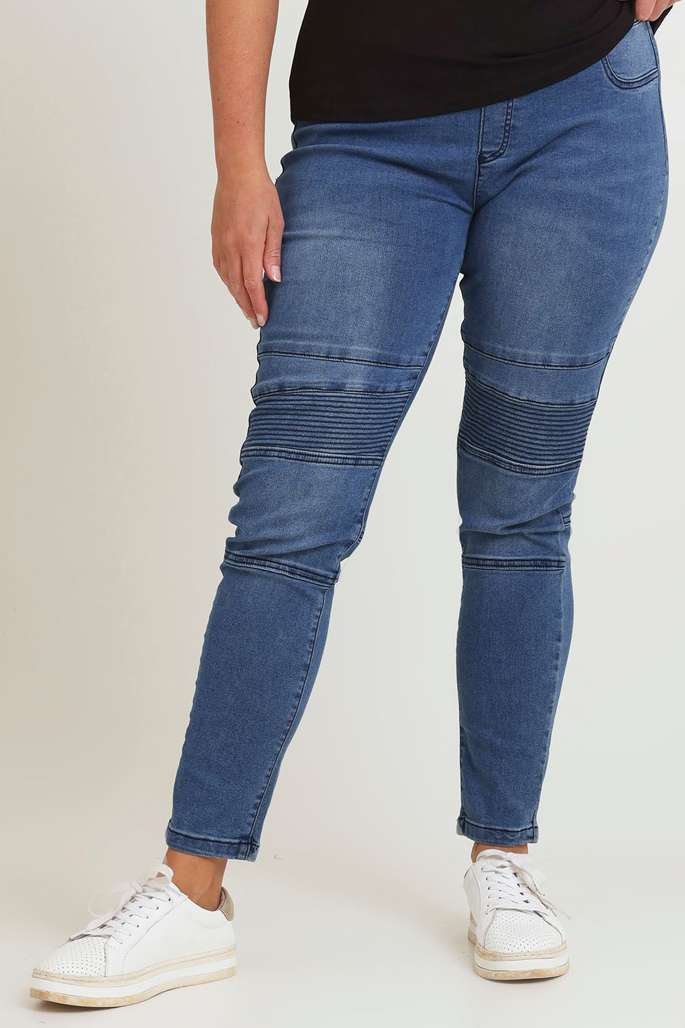 Model Chanel wearing size 16 of the River Ribbed Pull On Jean in colour Midblue (Blue), from the front, cropped image