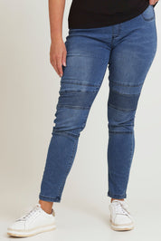 Model Chanel wearing size 16 of the River Ribbed Pull On Jean in colour Midblue (Blue), from the front, cropped image