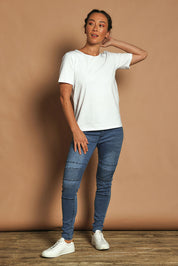 Model Katie wearing size 10 of the River Ribbed Pull On Jean in colour Midblue (Blue), from the front, showing the whole outfit