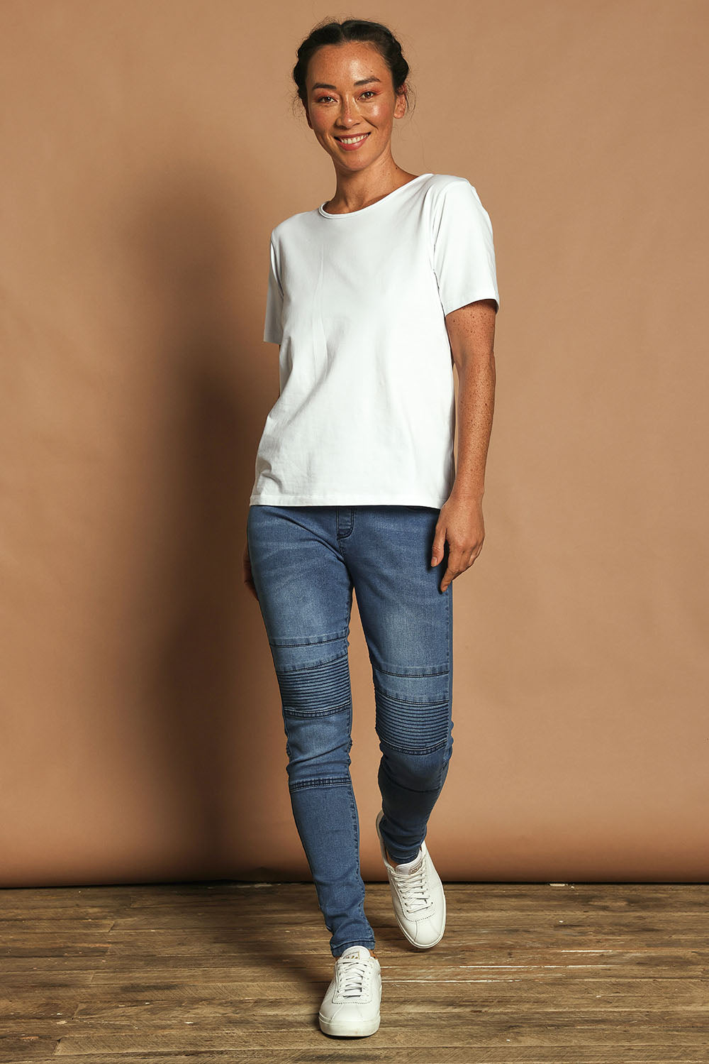 Model Katie wearing size 10 of the River Ribbed Pull On Jean in colour Midblue (Blue), from the front, showing the whole outfit