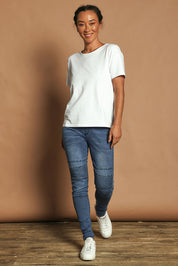 Model Katie wearing size 10 of the River Ribbed Pull On Jean in colour Midblue (Blue), from the front, showing the whole outfit