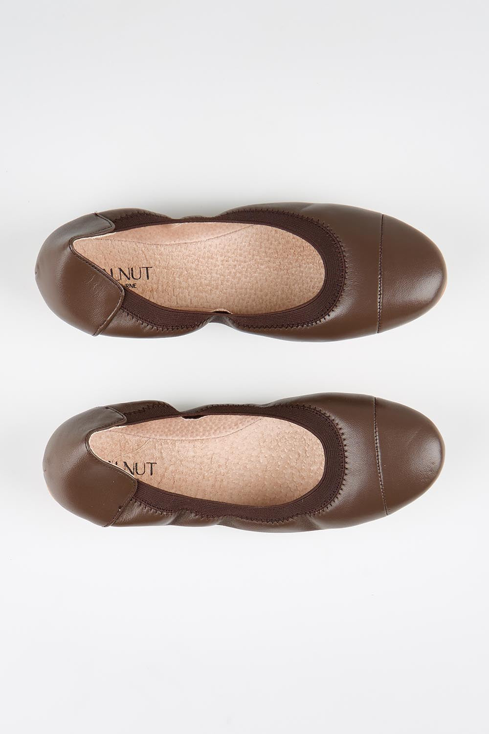 Model Genericm wearing size sample of the Ava Leather Flat - Chocolate in colour Chocolate, in a cropped view