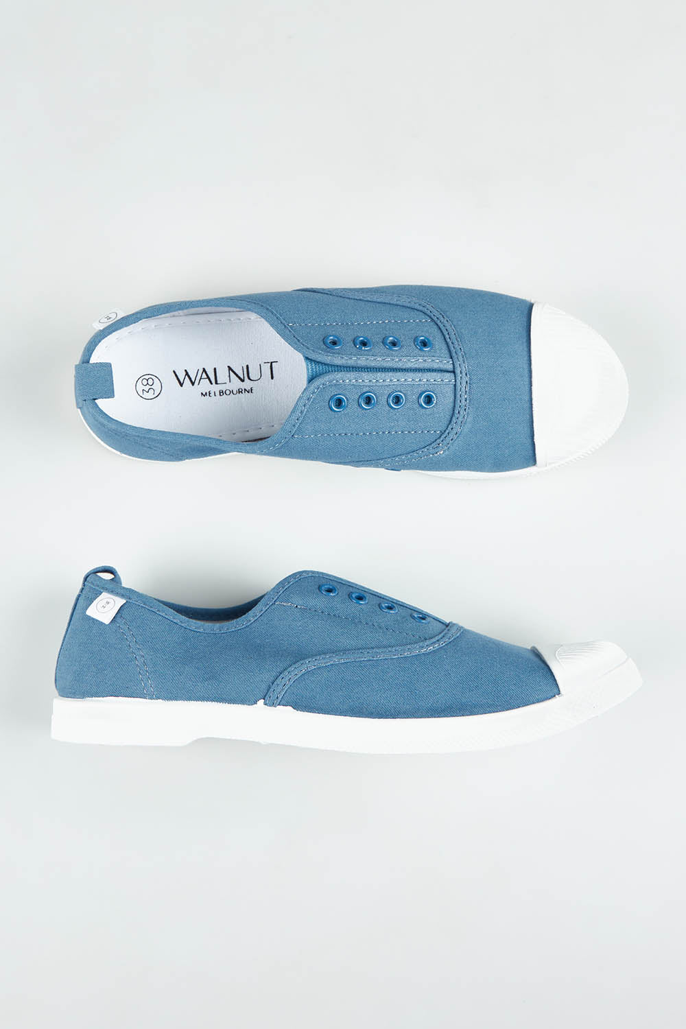A model wearing size 37 of the Euro Plimsole in colour Denim (Blue), from the front, showing the whole outfit