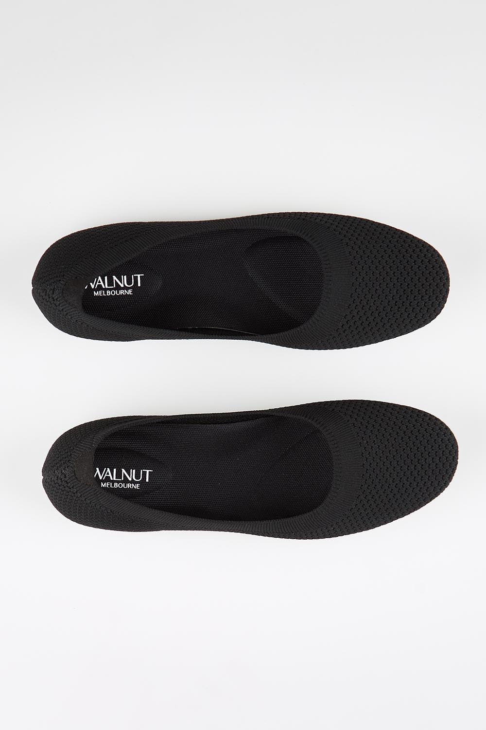 Model Genericm wearing size sample of the Eva Knit Ballet Flat - Black in colour Black, in a cropped view