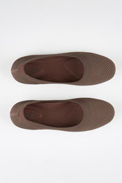 Model Genericm wearing size sample of the Eva Knit Ballet Flat - Chocolate in colour Chocolate, in a cropped view