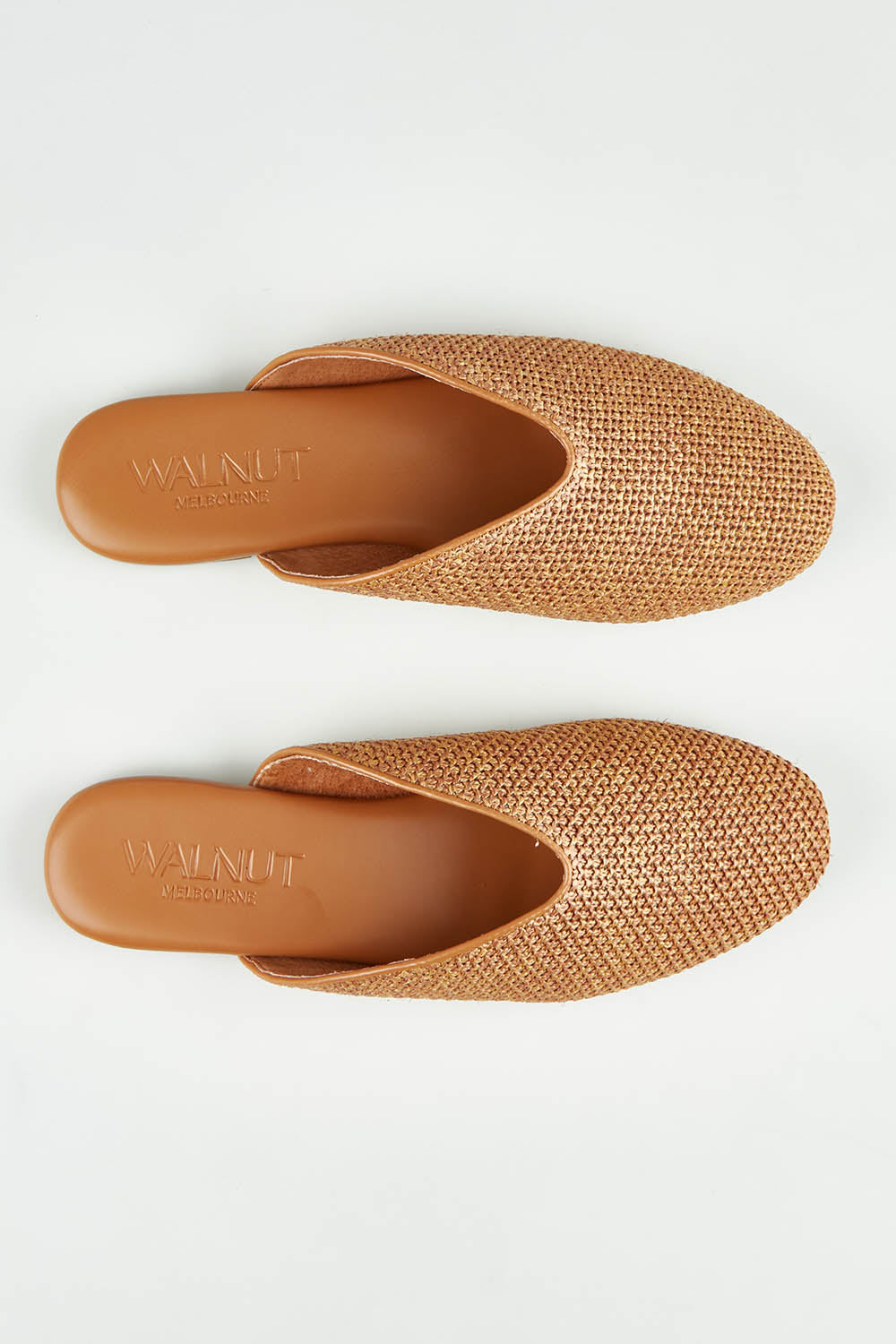 A model wearing size 37 of the Shana Mule in colour Natural, from the front, showing the whole outfit