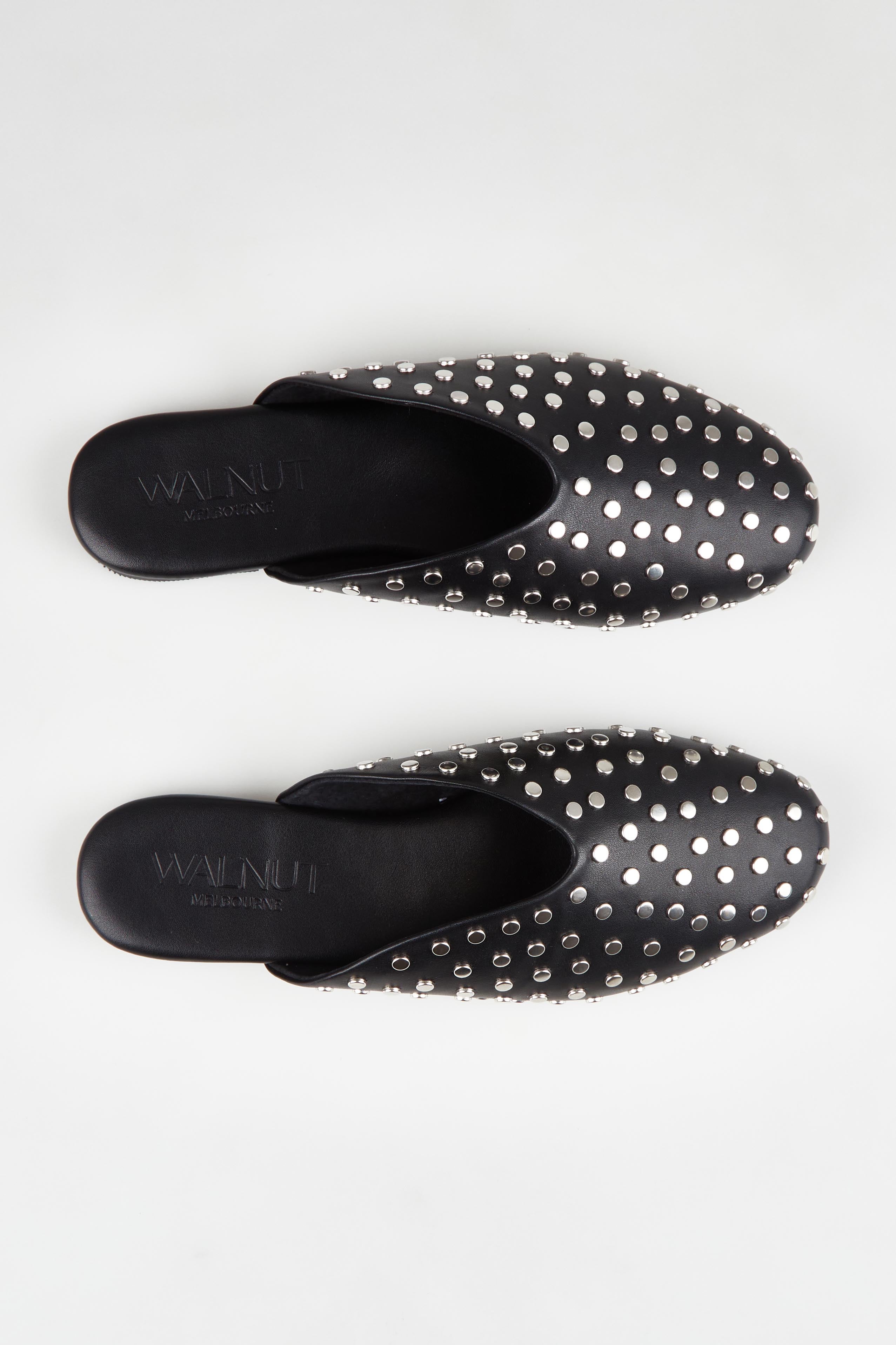 A model wearing size 37 of the Soho Studded Mule in colour Black (Black), from the front, showing the whole outfit