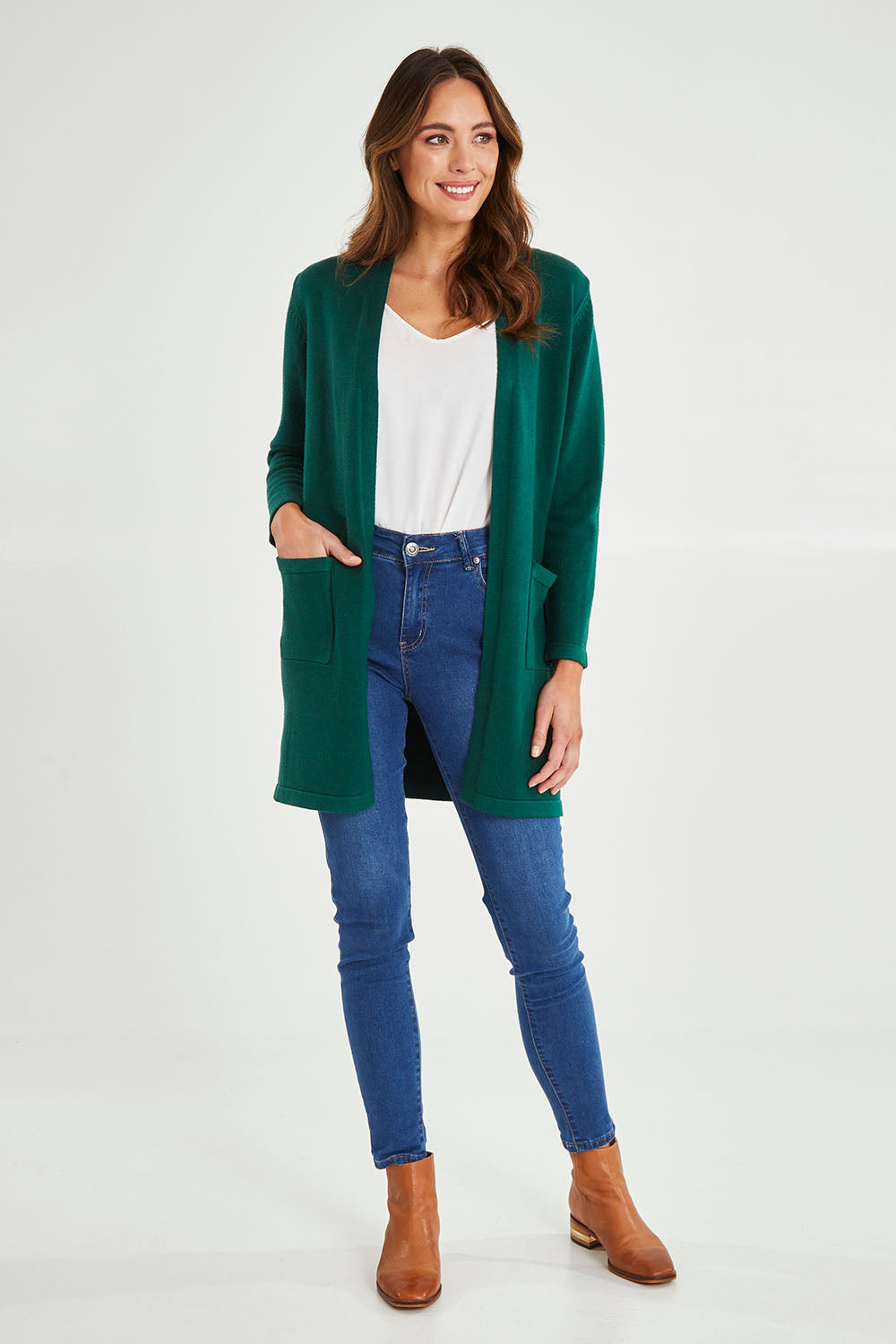 Model Madeline wearing size S of the Long Sleeve Open Cardi in colour Forest (Green), from the front, showing the whole outfit
