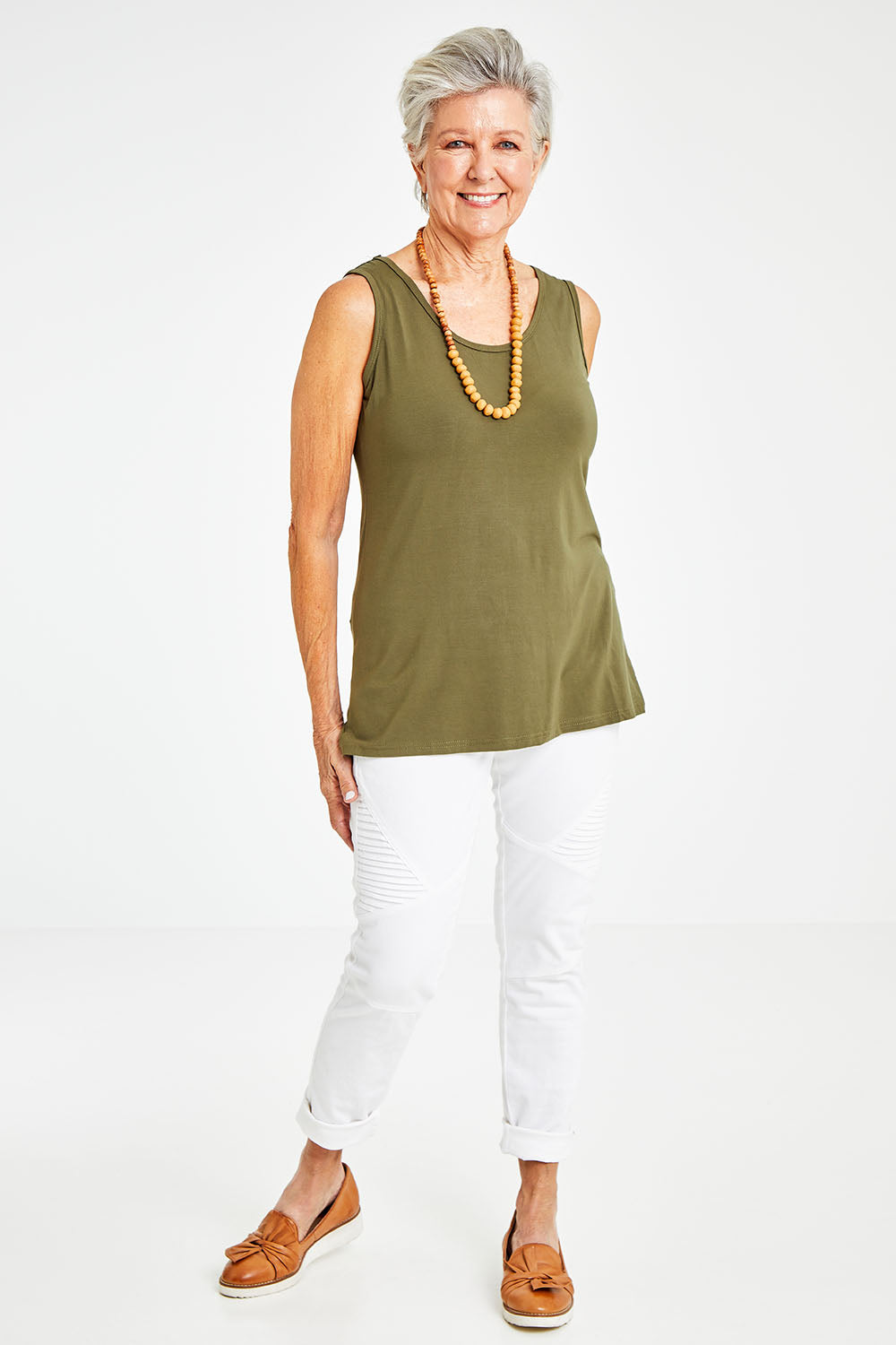 Model Elise wearing size S of the Drape Bamboo Cami in colour Olive (Green), from the front, showing the whole outfit