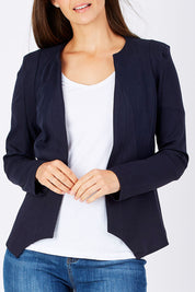 Model Anna wearing the Persuit Jacket in colour Navy (Blue), from the front, cropped image