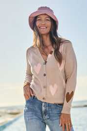 Model Alex wearing size S of the Hearts For You Cardi in colour Birch, from the front, showing the whole outfit