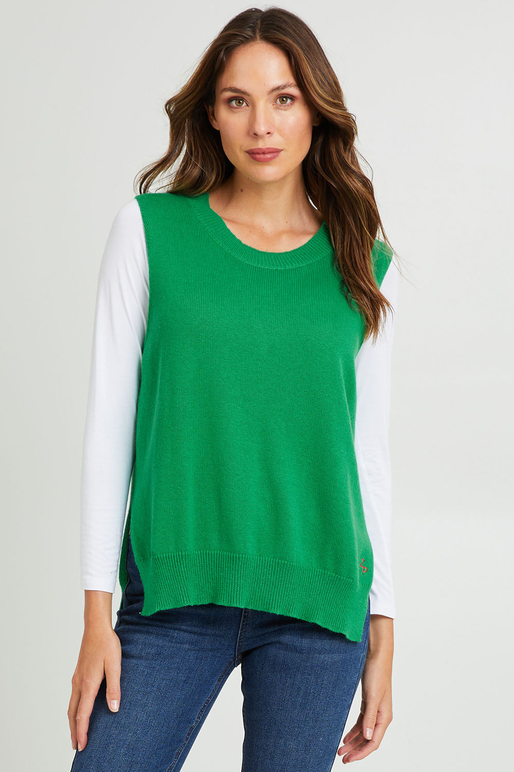 Model Madeline wearing size S of the Essential Vest in colour Emerald (Green), from the front, cropped image